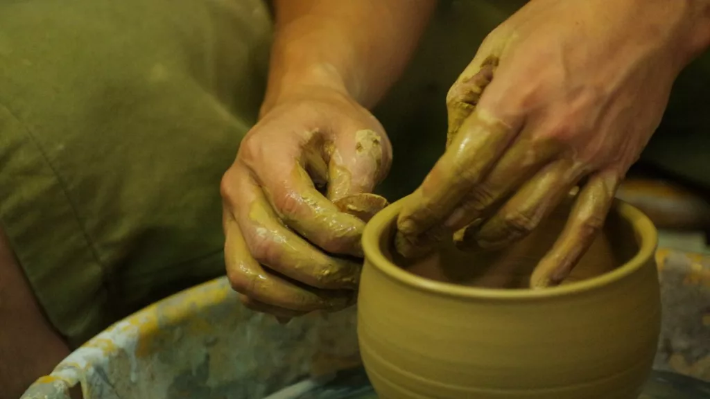 Artesano creando una vajilla con arcilla.